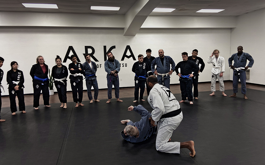 Adult jiu-jitsu Training: Adults practicing jiu-jitsu techniques