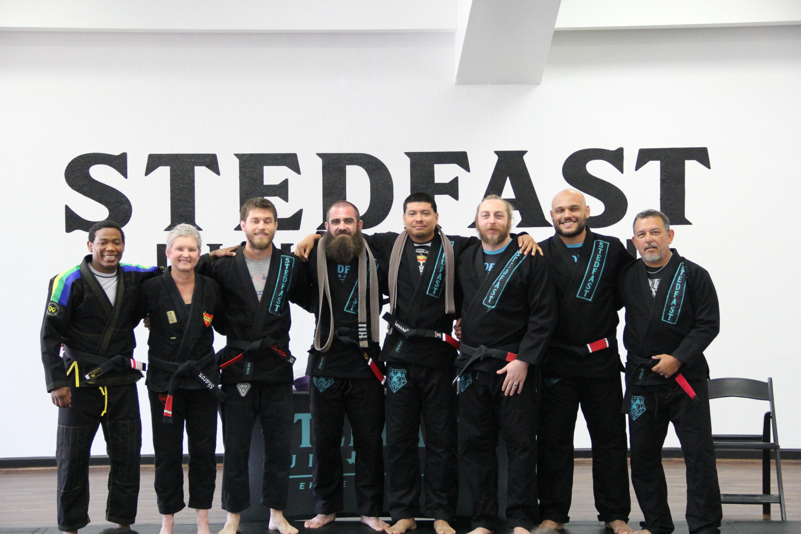 Adult jiu-jitsu Training: Adults practicing jiu-jitsu techniques